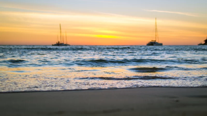 Soft waves on the sand at sunset. Selective focus.