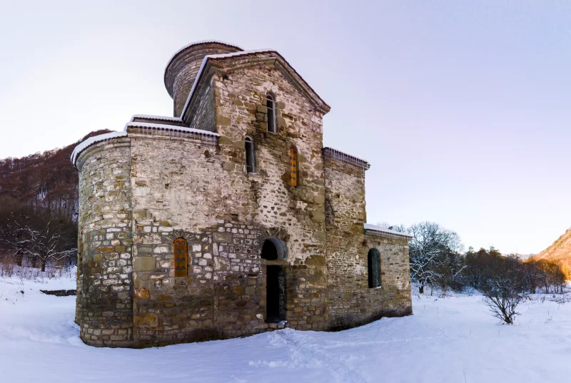 Ancient church in snowy forest