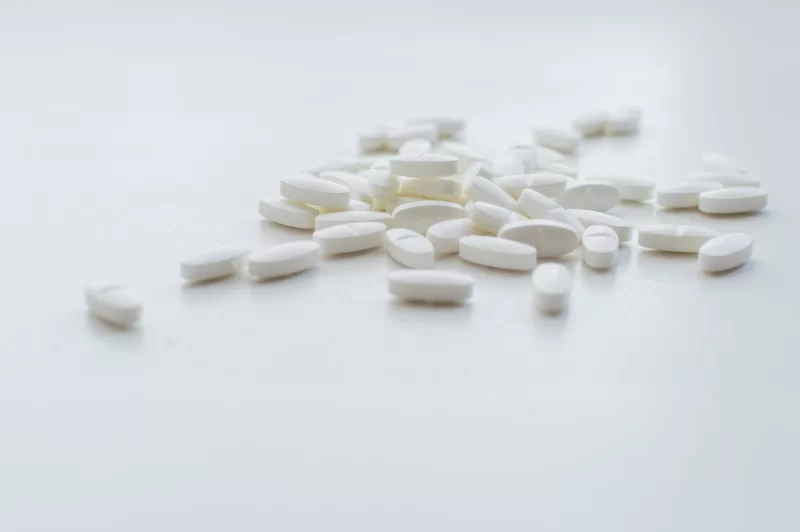Белые таблетки на белом фоне