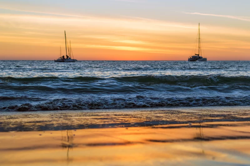 Sailing boats on the sea at sunset.