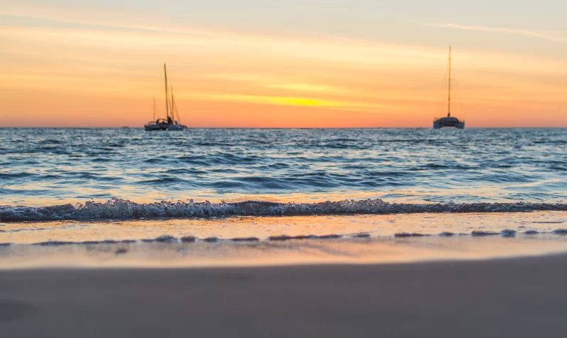 Sailing boats on the sea at sunset.