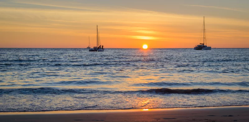Sailing boats on the sea at sunset.