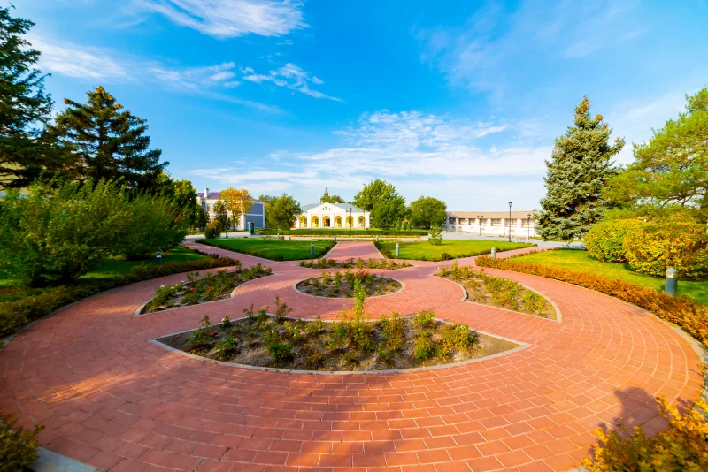 Flowerbeds, Grass Pathway and Ornamental Vase in a Formal Garden