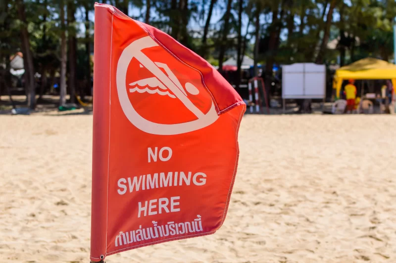 Red flag on Beach No Swimming sign