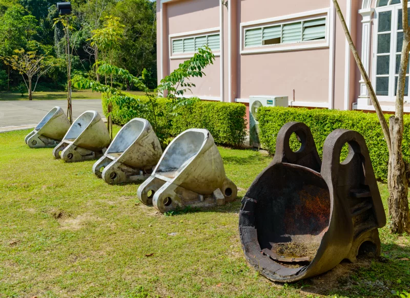 Old and new buckets for of tin mining operations