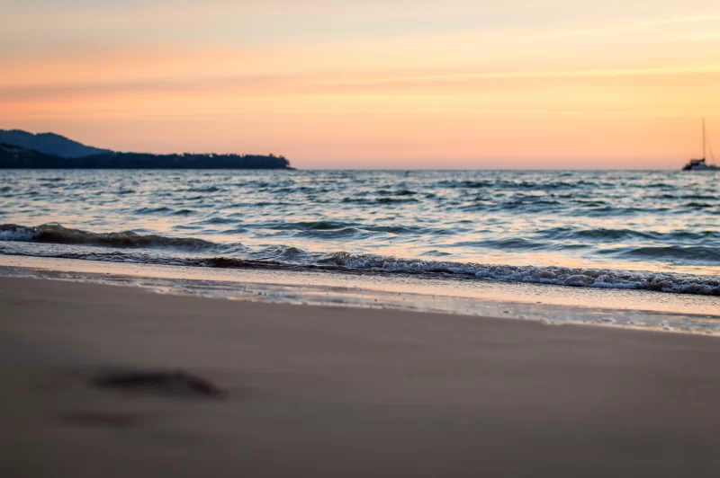 Soft waves on the sand at sunset