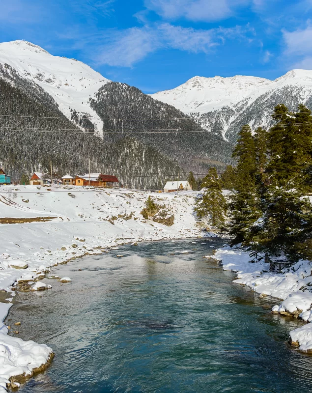 Winter river near snow-capped mountains