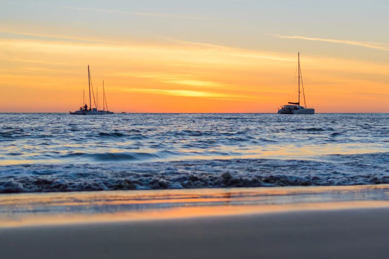 Sailing boats on the sea at sunset.