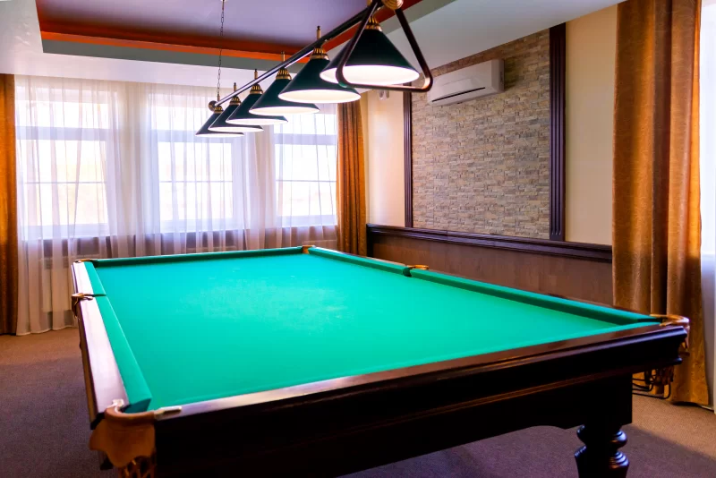 Billiard room with green felt and lighting
