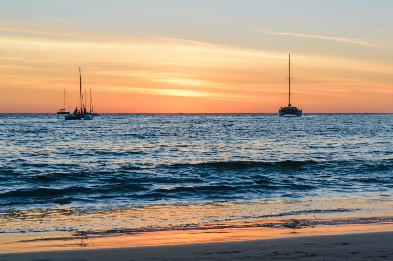 Sailing boats on the sea at sunset.