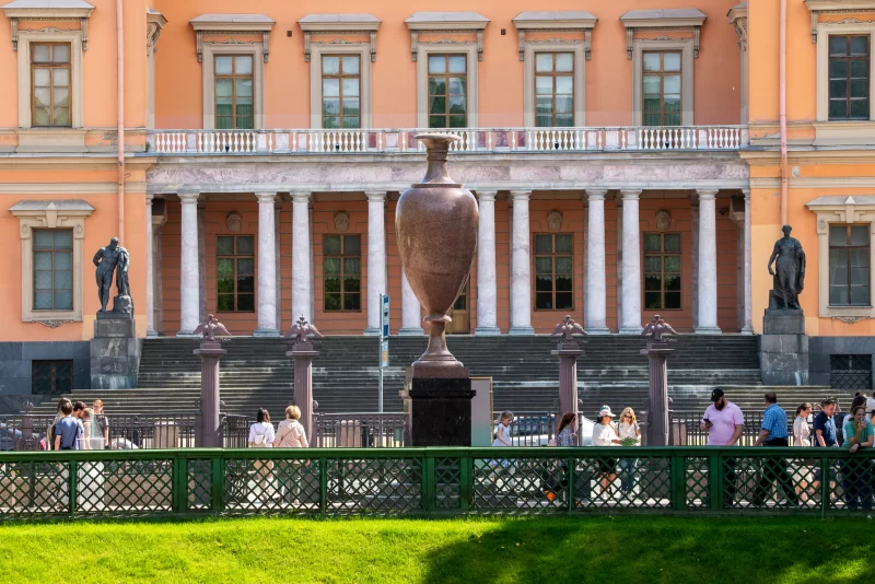 Facade of building with vase and people